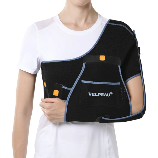 A black shoulder and arm support brace with light blue trim and small orange accents, worn on a model's upper arm and shoulder. The brand name 'VELPEAU' is printed in white on a front patch.